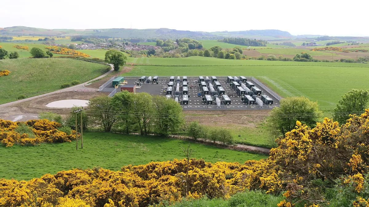 Aerial view of a battery plant with dozens of containers on rural land