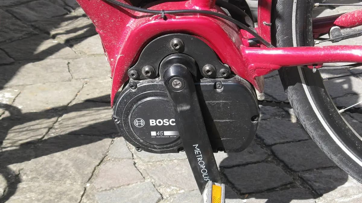 Motor central Bosch montado no eixo dos pedais de uma bicicleta elétrica vermelha