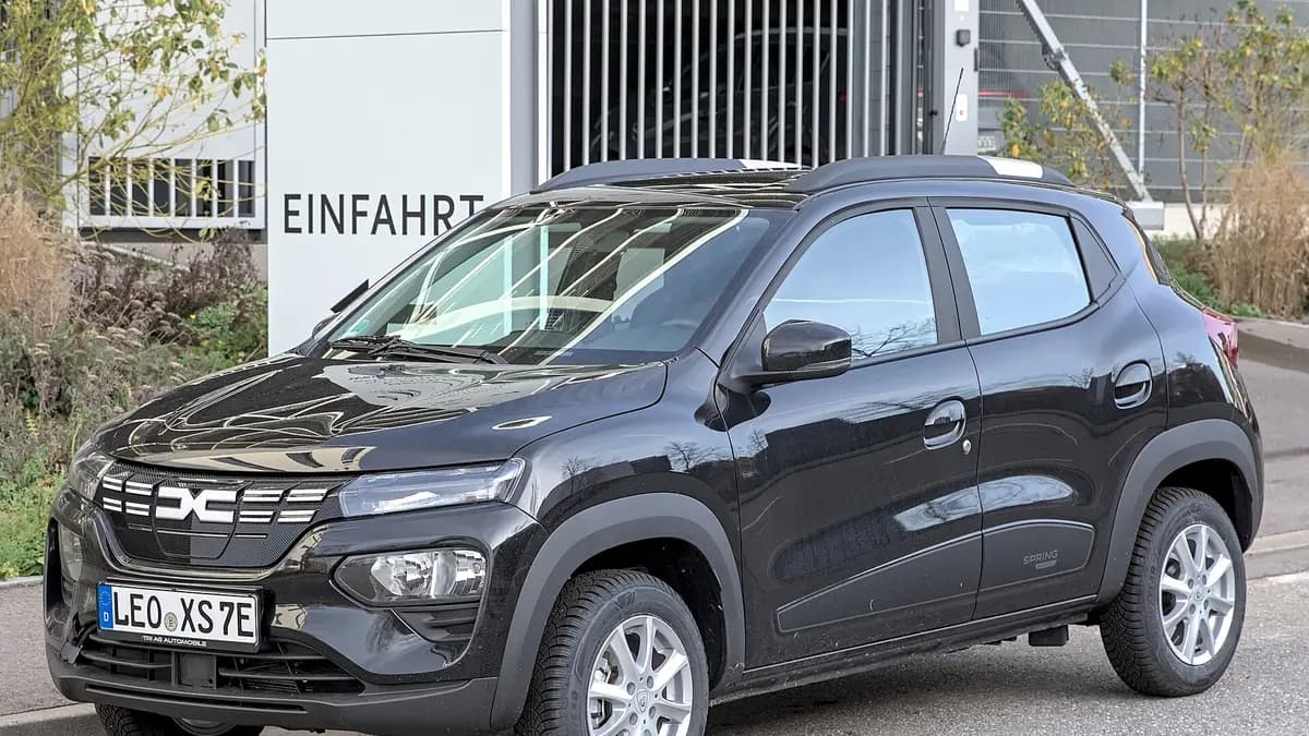 Black Dacia Spring compact electric car parked on a street