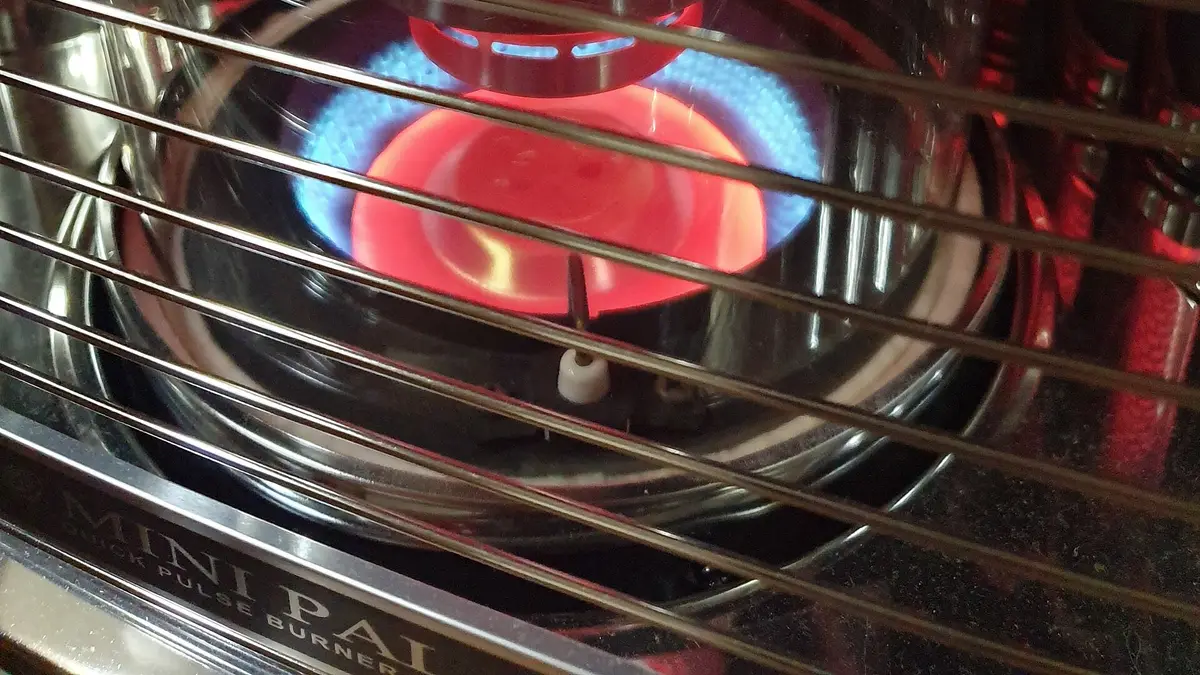 Chama azul acesa dentro de um aquecedor a querosene