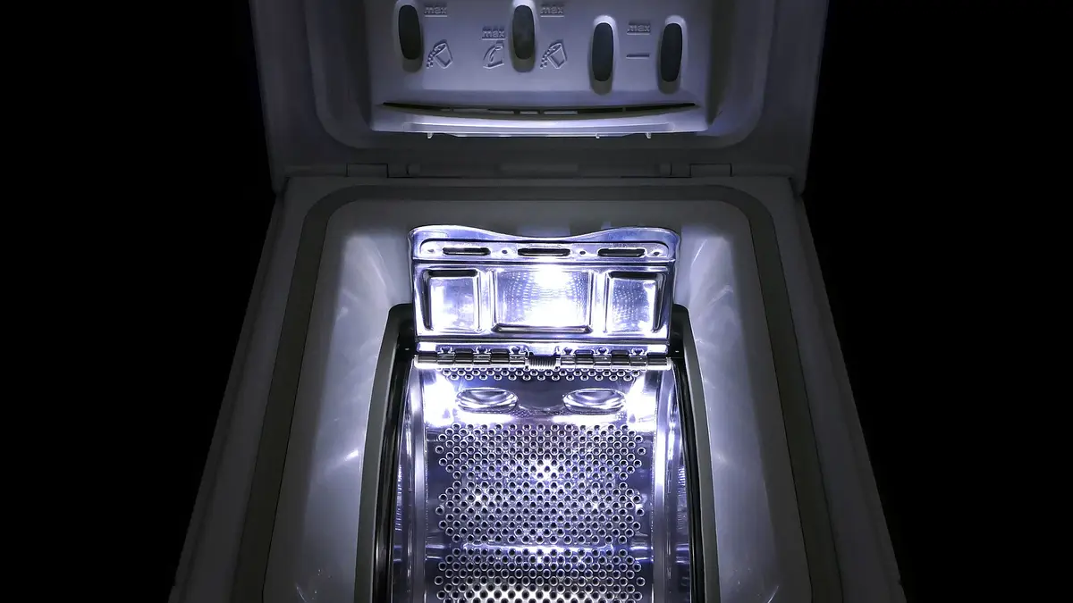 Illuminated interior of an open top-loading washing machine