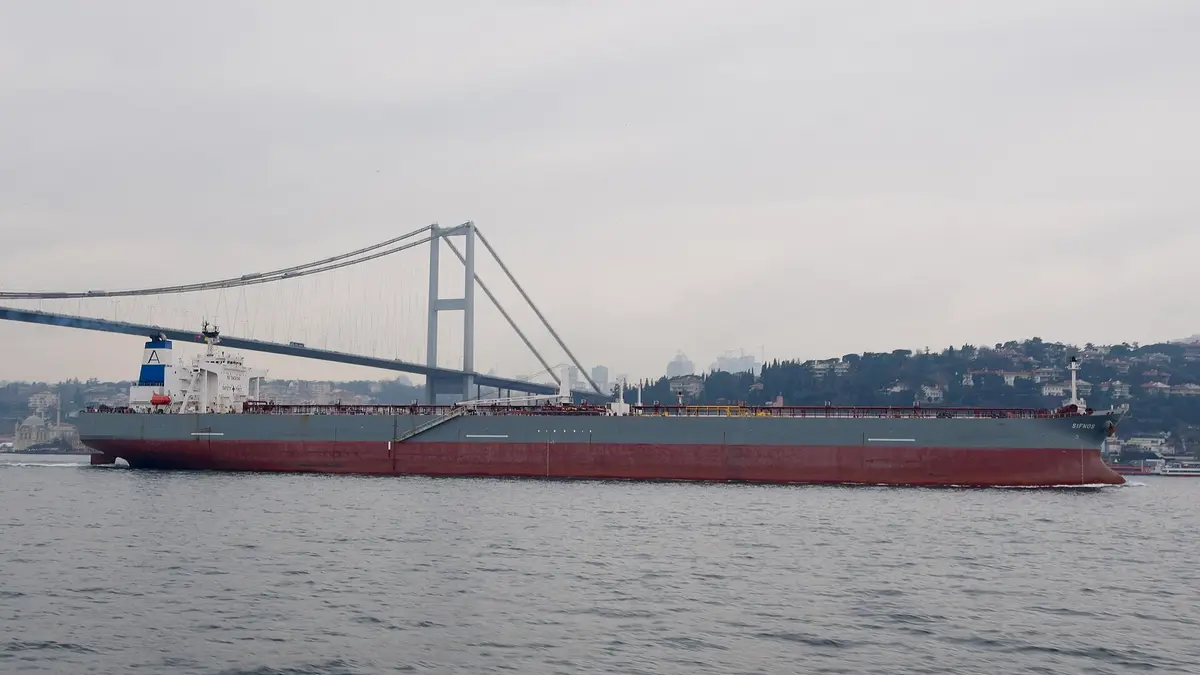 Oil tanker sailing through the Bosphorus Strait under a suspension bridge