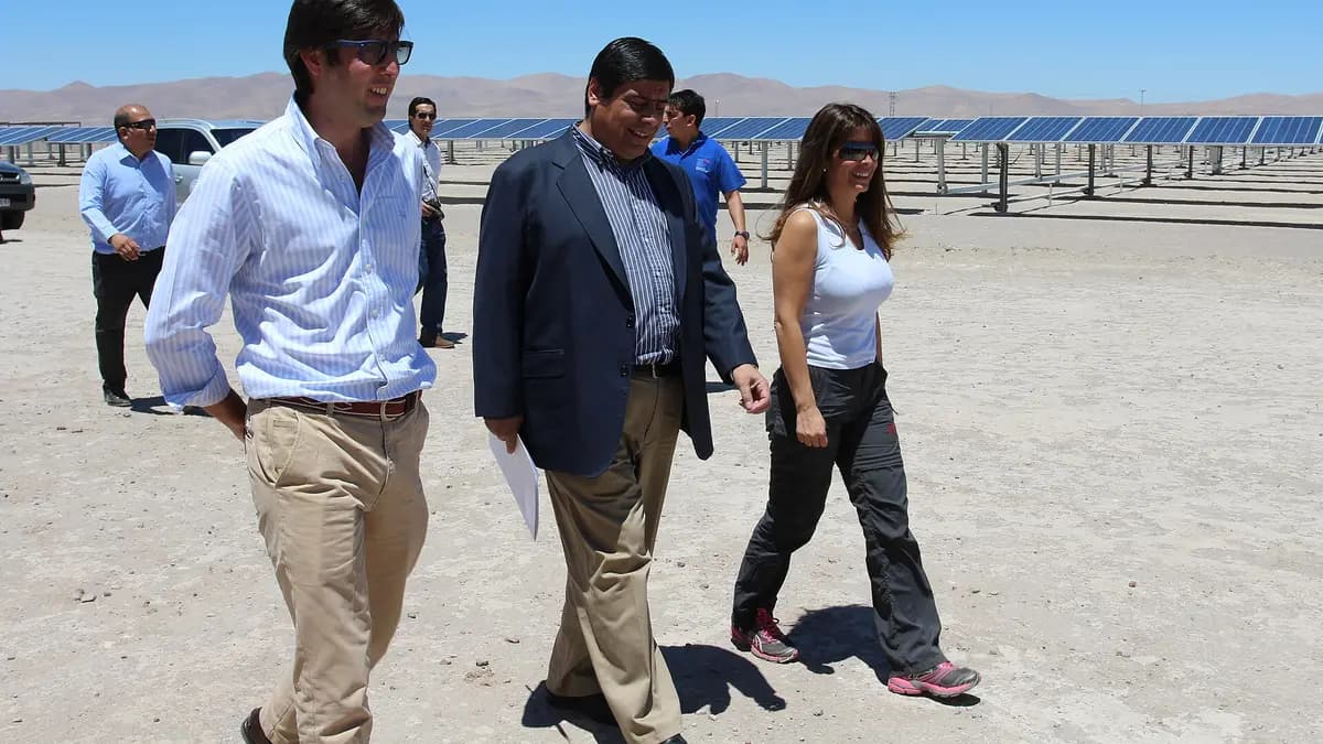 Officials tour the Pozo Almonte I photovoltaic plant, with rows of solar panels in the desert