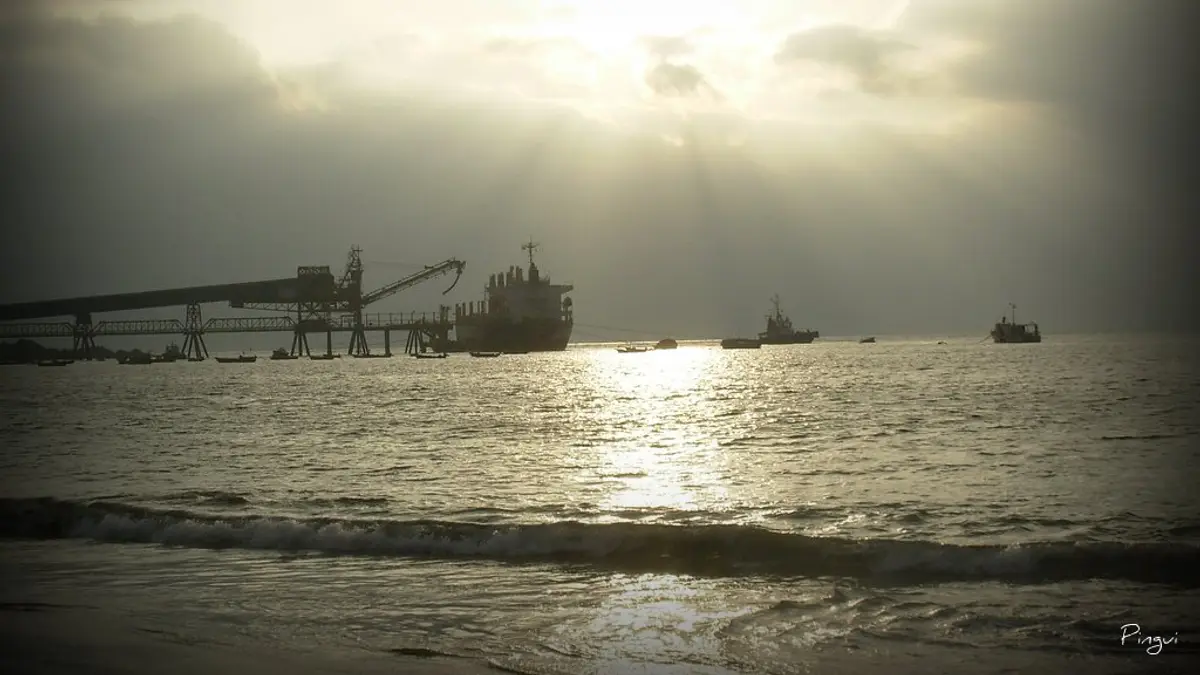 Industrial pier at Puerto Coloso at sunset with a ship and calm sea