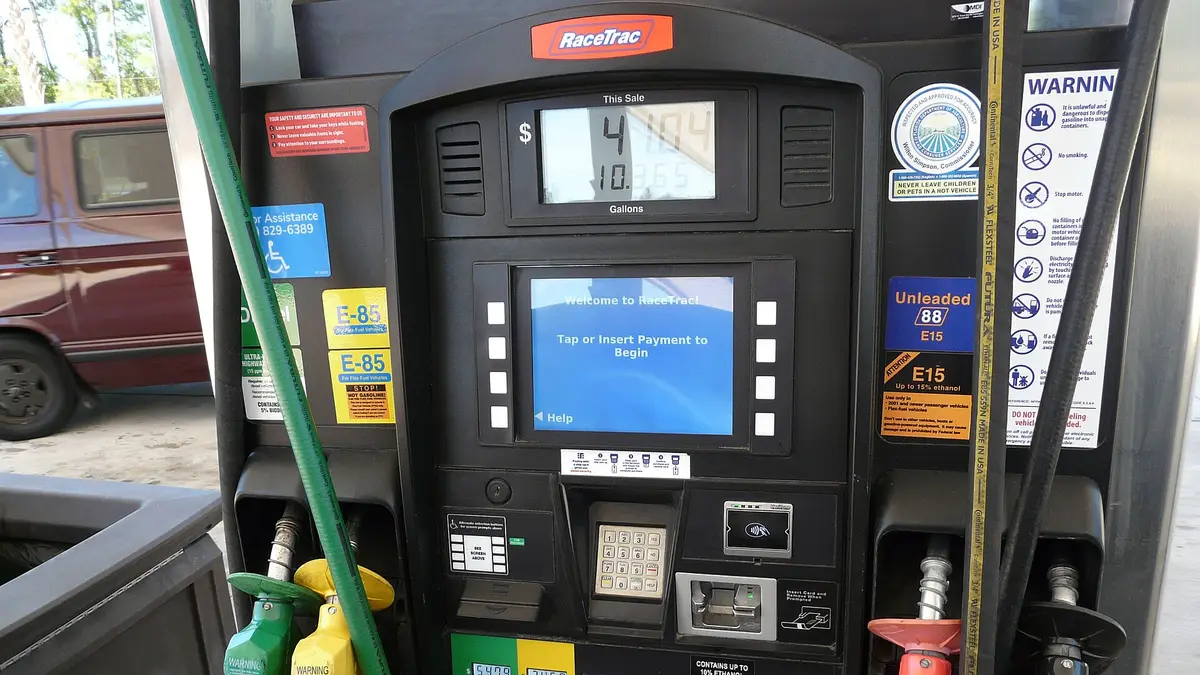 Fuel pump at a service station with hoses for different fuels