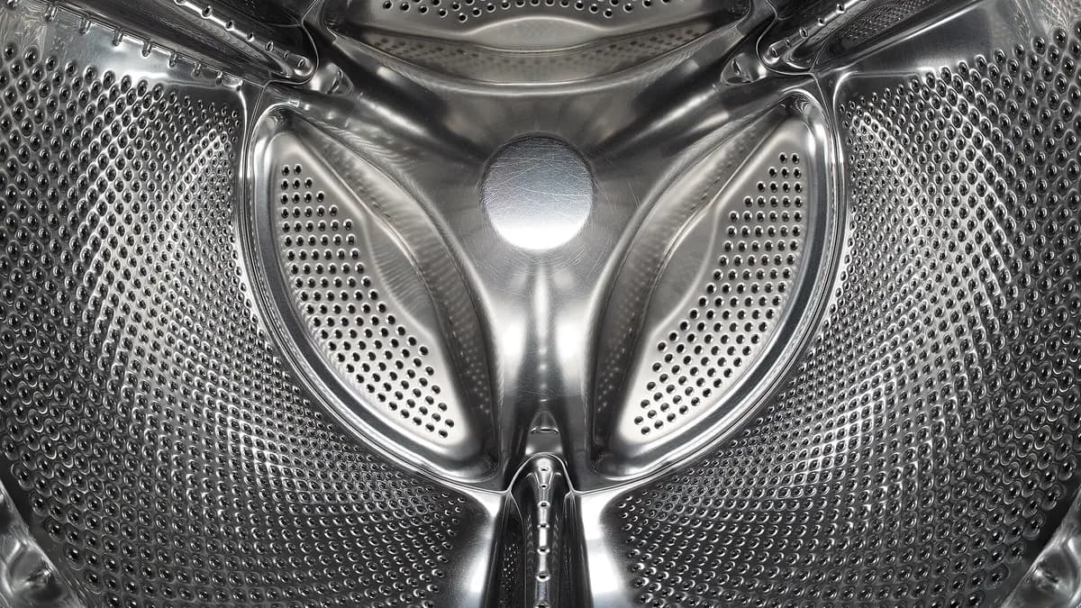 Inside the stainless steel drum of a front-loading washing machine